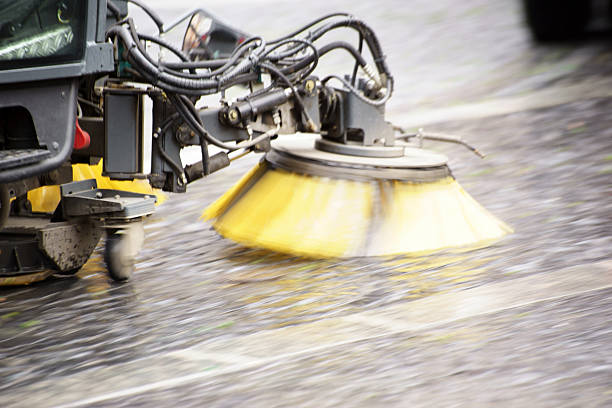 Closeup at Black Nylon brush of the Road sweeper Cleaning equipment low angle camera near the concrete floor
