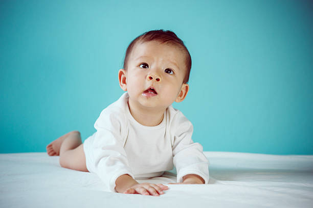 istock Cute Baby crawling on White bed, studio shot 479762602