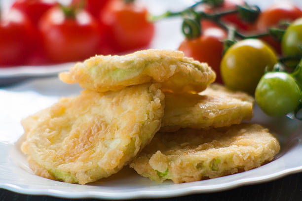 Fried Zucchini and red cherry tomatoes stock photo