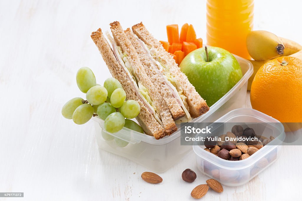 school lunch with sandwich on white wooden table, close-up school lunch with sandwich on white wooden table, close-up, horizontal 2015 Stock Photo