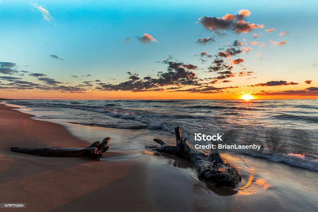 Driftwood on a Lake Huron Beach at Sunset Driftwood on a Lake Huron Beach at Sunset - Grand Bend, Ontario, Canada 2015 Stock Photo