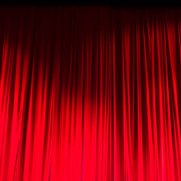 istock Red closed curtain with light spots in a theater 479774284