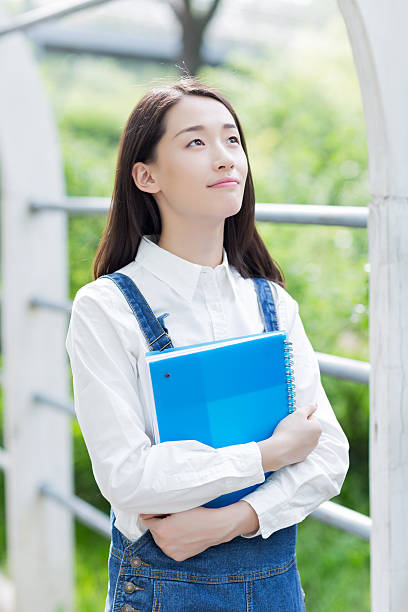 istock girl reading outdoors 479774500