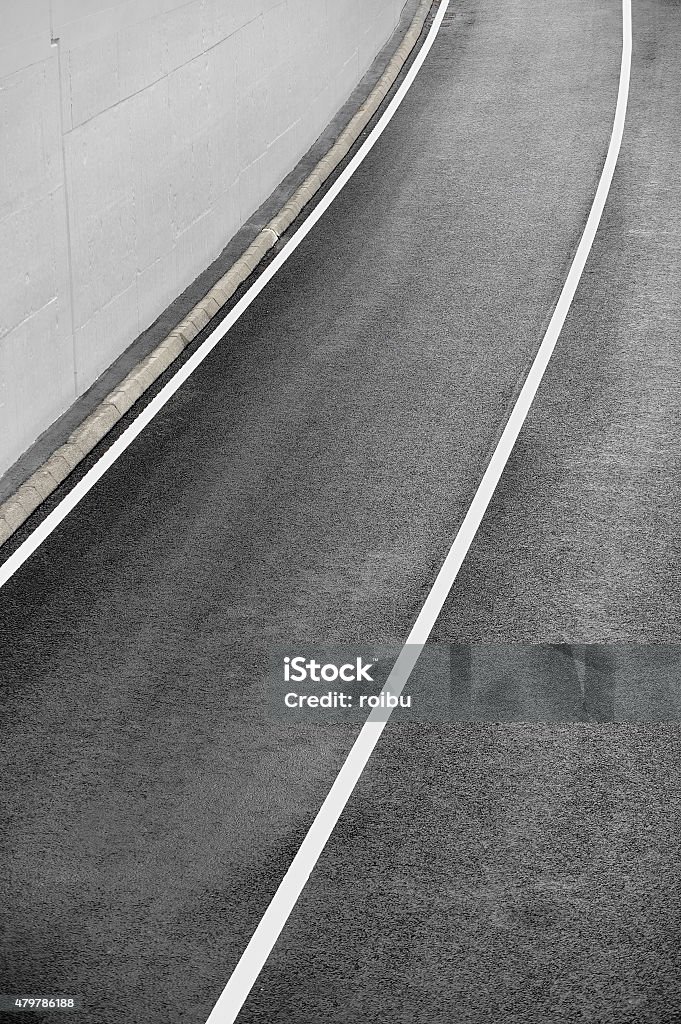 New asphalt road Industrial shot with a new asphalt two lane road coming out of a tunnel 2015 Stock Photo