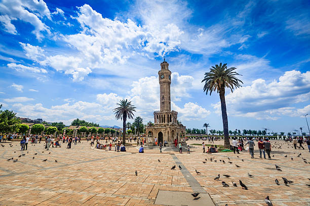 Clock tower in  Izmir - stock image Izmir Konak square with Historical Clock Tower-Saat Kulesi . It was built in 1901, in order to commemorate the 25th anniversary of Abdulhamid II accession to the throne. The tower is 25 metres high and has 4 fountains around the circular base. It is a the symbol of Izmir City. clock tower stock pictures, royalty-free photos & images
