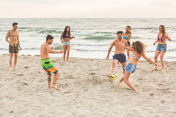 istock Group of friends playing with ball on the beach 479794496