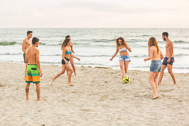 istock Group of friends playing with ball on the beach 479794596