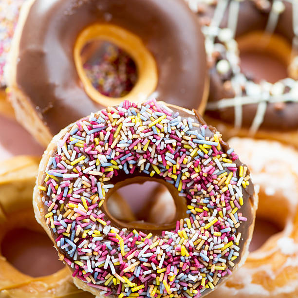 istock Glazed Doughnuts with colourful sprinkles, chocolate, icing 479795290