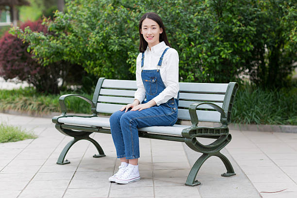 happy girl sitting on the bench, asian woman