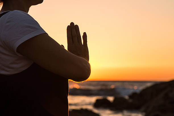 istock Silhouette young woman practicing yoga on the beach at sunset. 479797972