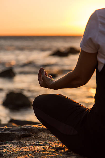 istock Silhouette young woman practicing yoga on the beach at sunset. 479799416