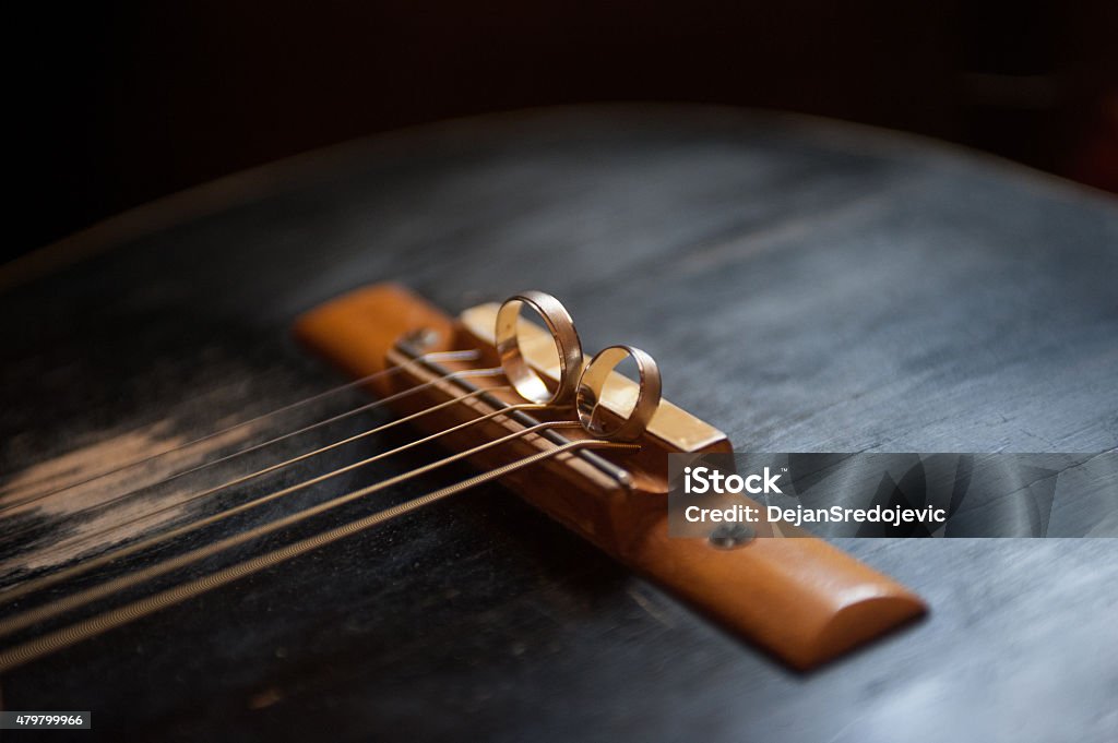 Weeding rings on the old guitar Wedding rings Guitar Stock Photo