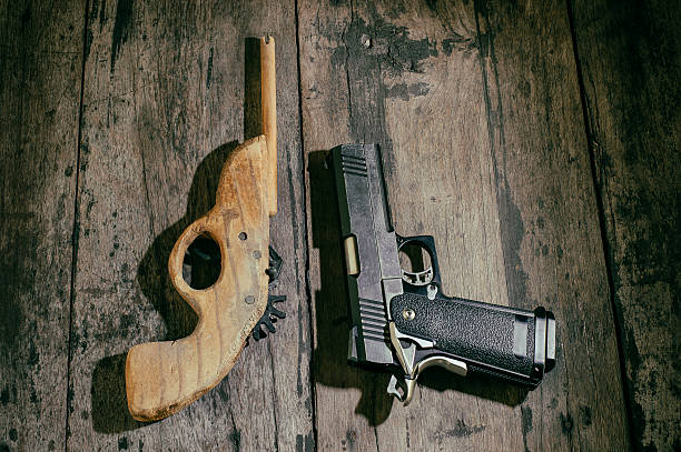 boy toy gun boy's toy gun, in the wood desk wooden toy gun stock pictures, royalty-free photos & images