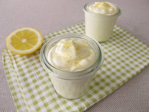 Lemon curd cheese dessert in glass stock photo