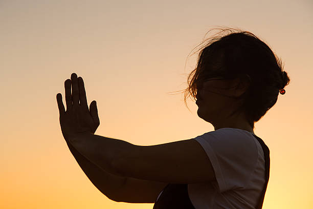 istock Silhouette young woman practicing yoga on the beach at sunset. 479801226