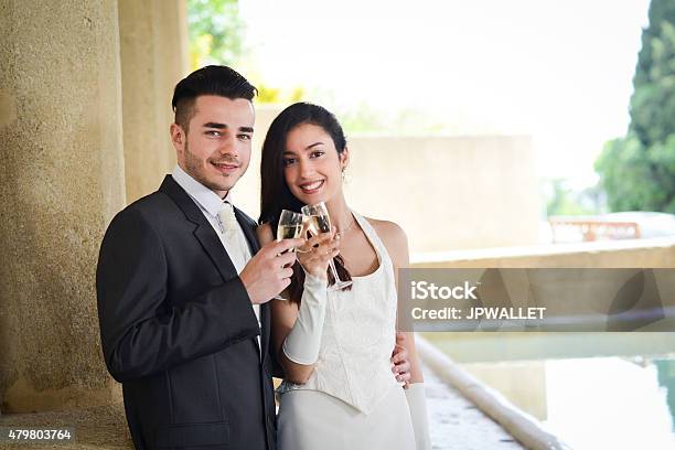 Cheerful Couple Bride And Groom Cheering With Champagne On Wedding Stock Photo - Download Image Now