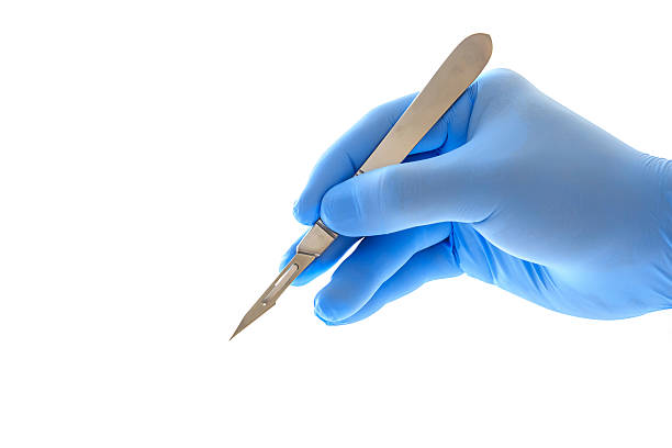 Doctor's hand holding a scalpel Doctor's hand holding a scalpel with clipping path scalpel photos stock pictures, royalty-free photos & images