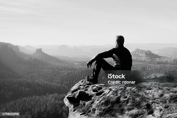 Tourist Hiker Man On The Rock Peak In Rocky Mountains Stock Photo - Download Image Now