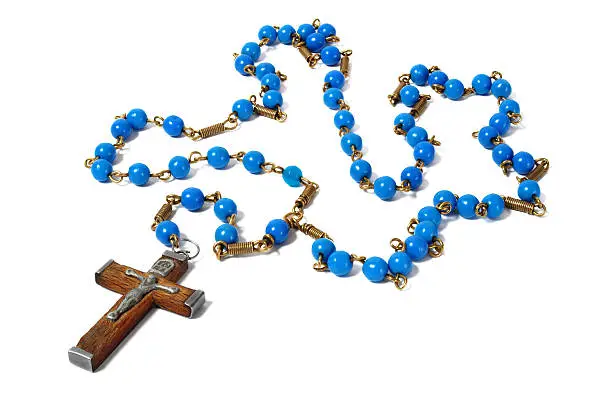 Rosary with blue beads on white background