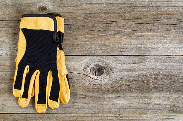 istock New leather and nylon work gloves on rustic wooden boards 479805826