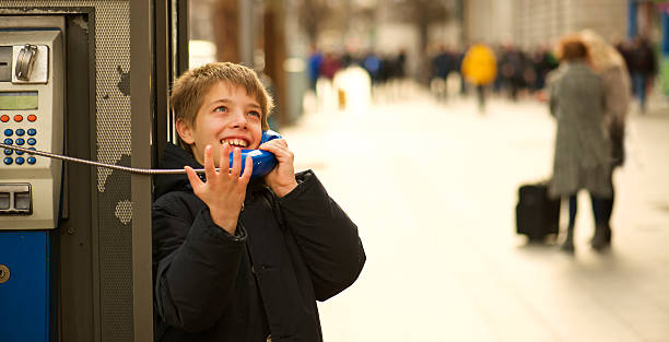 istock kid use  payphone to reassure  his trip is going well 479807550