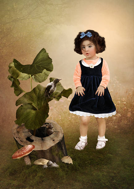 The little girl with surprised look is looking on crow sitting on a leaf of burdock