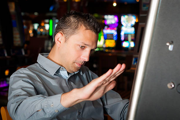 istock Young man playing a slot machine 479811198