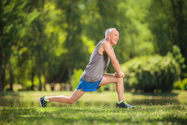 istock Ssenior stretching exercises in a park 479814496