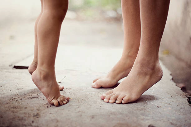 istock Mother and daughter standing on their toes 479817360
