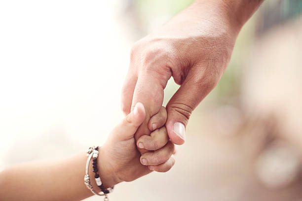 istock Father holding hands of his daughter 479817372
