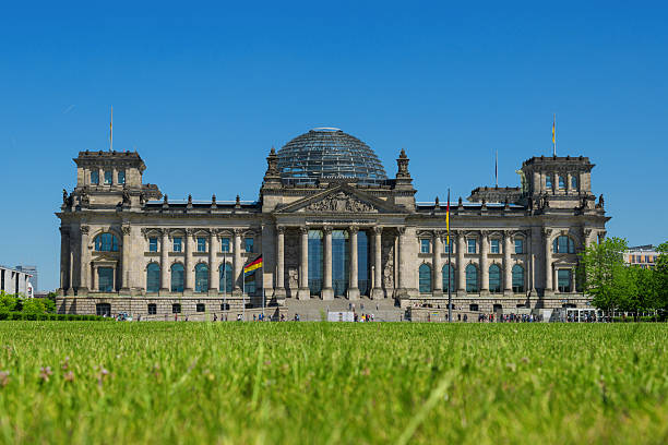 German Reichstag in Berlin with green grass The German Parliament (Deutscher Bundestag), Reichstag Building is one of Germany's most famous sights. bundestag photos stock pictures, royalty-free photos & images