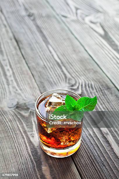 Glass Of Cola With Ice And Mint On Wooden Table Stock Photo - Download Image Now - 2015, Bar - Drink Establishment, Black Color
