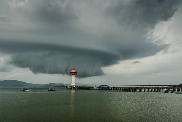 istock ranong pier light house and cumulonimbus 479818626