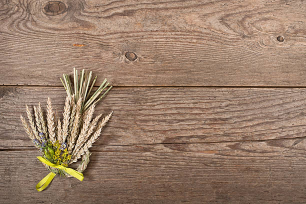 istock bundle of wheat with flower and band on the table 479821230