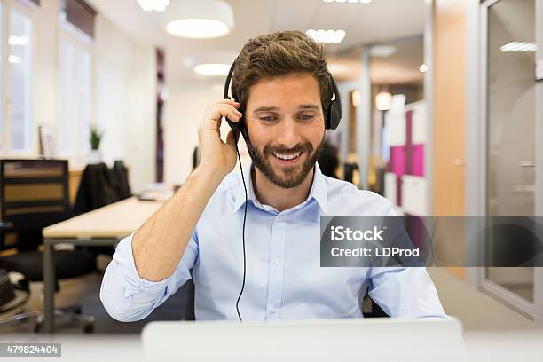 Smiling Businessman In The Office On Video Conference Headset Stock Photo - Download Image Now