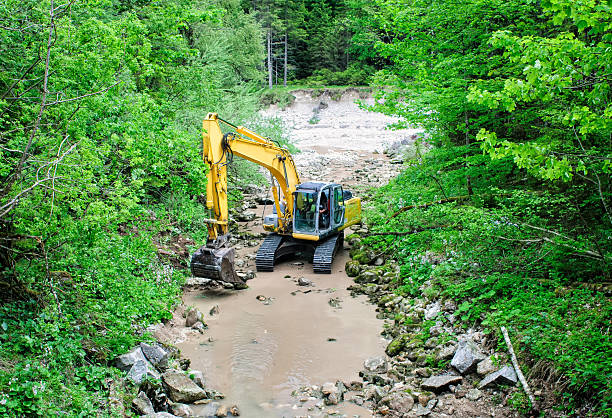 istock Dredger works in the trough of mountain stream. 479824406