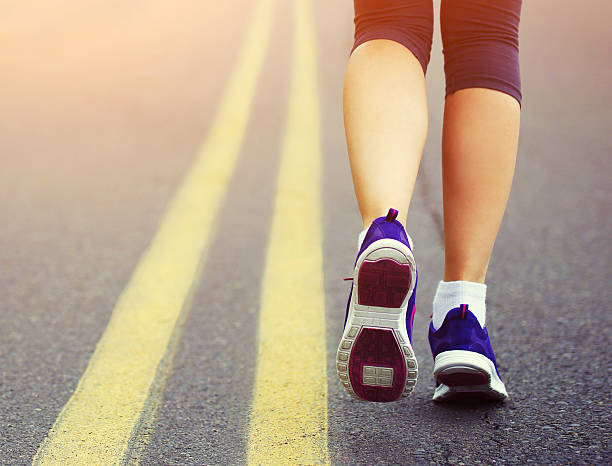 istock Runner Female Feet Running on Road 479830474
