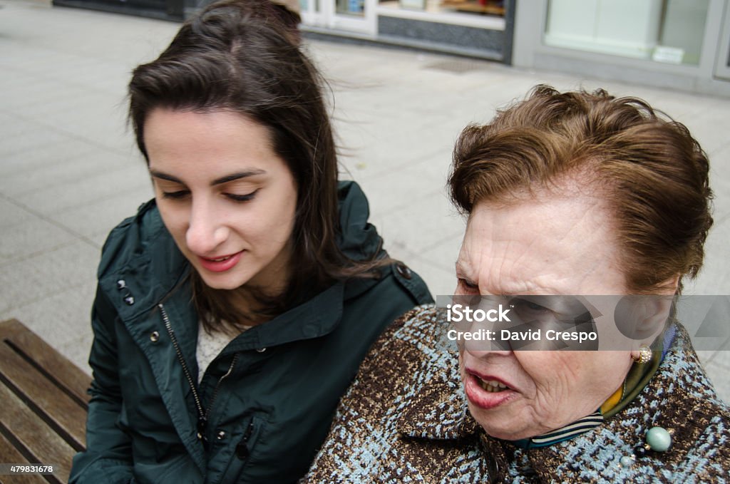 Granddaugher and grandmother None of them is looking directly to the camera. 2015 Stock Photo