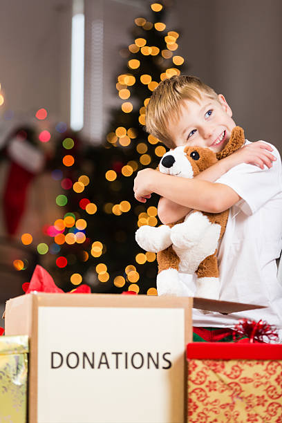 istock Happy little boy hugging stuffed animal before donating for Christmas 479835226