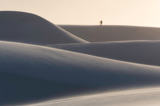 A lone photography at sunset in White Sands National Monument, New Mexico.