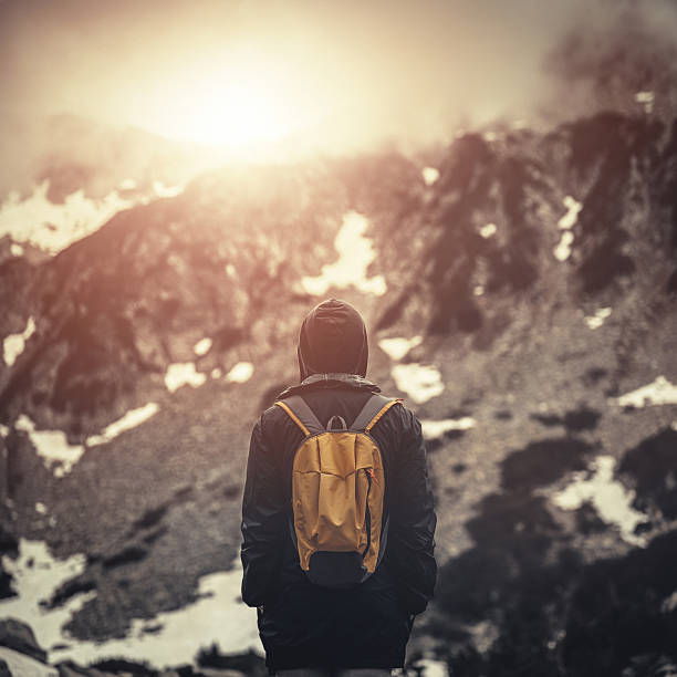istock Traveler with backpack walking in mountains at sunset 479845202