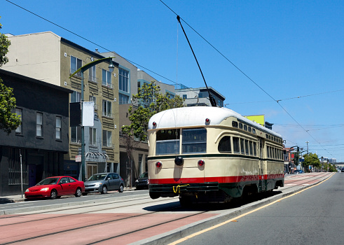 Vintage yellow and red San Francisco street car on Third Street. Horizontal.