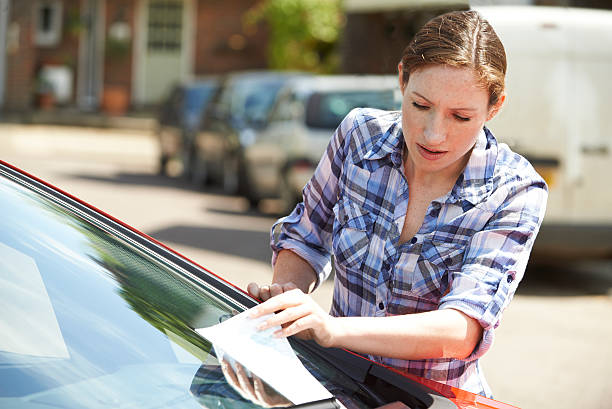 istock Frustrated Female Motorist Looking At Parking Ticket 479851124