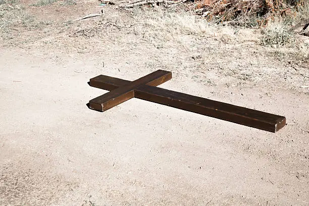 Photo of Christian Symbol of Wooden Cross on dusty track