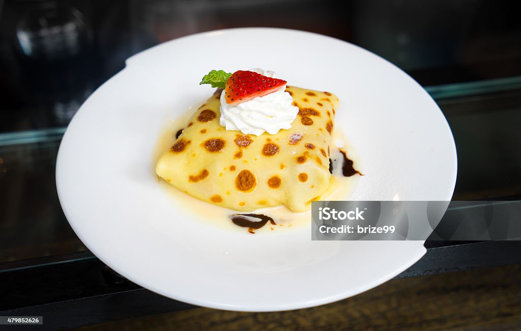 Crape cake with strawberry topping. Crepe cake.  2015 Stock Photo