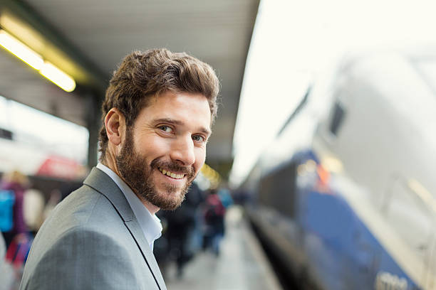 Portrait of cheerful man on railway station platform. Looking camera stock photo
