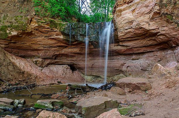 Secluded waterfall in forest, plunges into a canyon