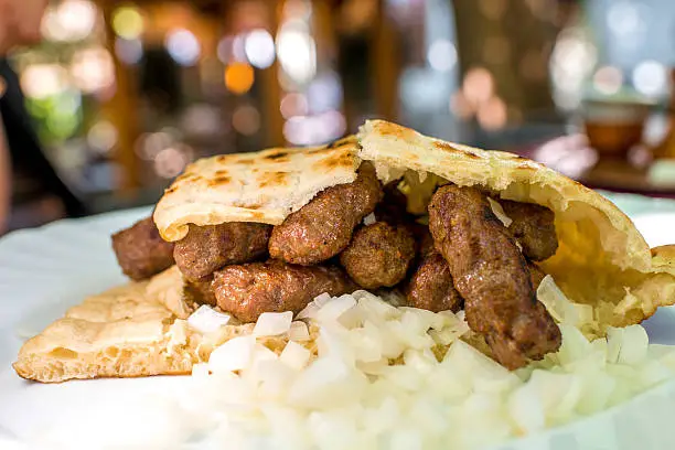 Traditional Bosnian food cevapi with onion and bread