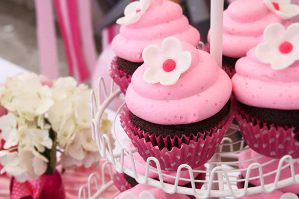 Bright Pink Flower Cupcakes on Display at a Birthday Party