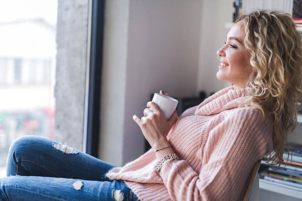 istock Young smiling woman enjoying in her coffee time. 479875952